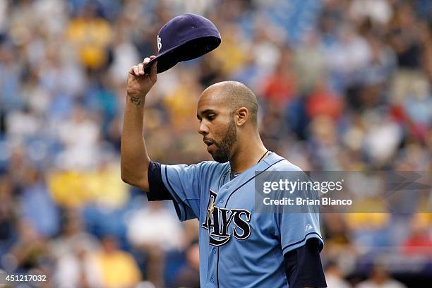 Pitcher David Price of the Tampa Bay Rays lifts his hat to the crowd as he comes off the mound after giving up a solo home run to Andrew McCutchen of...