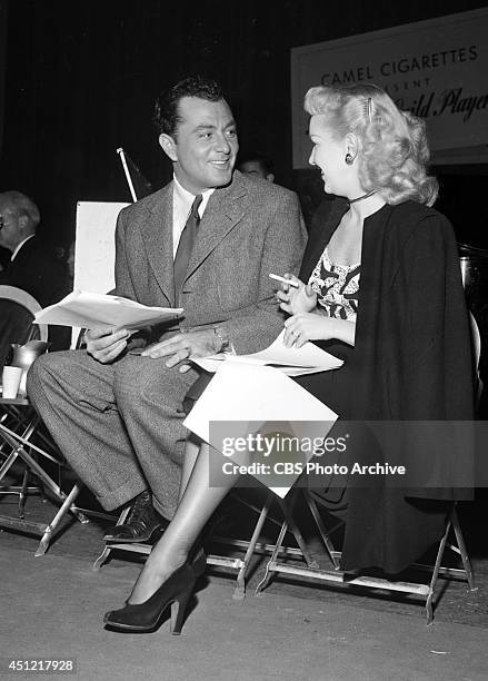 Singer Tony Martin and actress Betty Grable prepare for their appearance on the CBS radio program "SCREEN GUILD PLAYERS," on October 27 in Los...