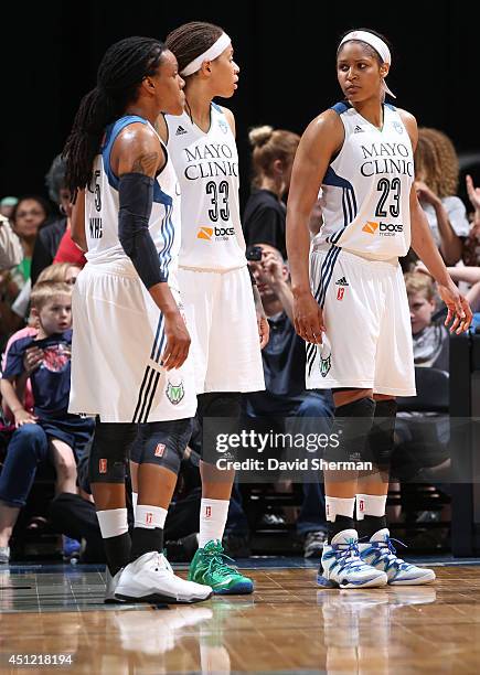 Tan White, Seimone Augustus and Maya Moore of the Minnesota Lynx stand on the court against the Indiana Fever during the WNBA game on June 22, 2014...