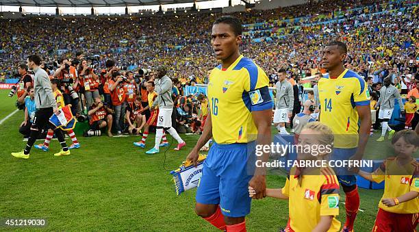 Ecuador's midfielder Antonio Valencia leads his team onto the pitch before the start of a Group E football match between Ecuador and France at the...