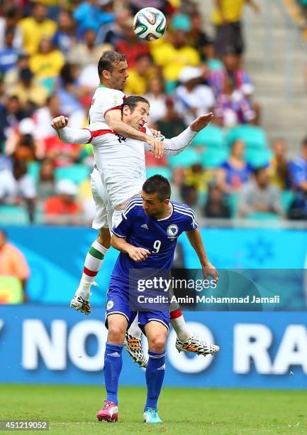 Andranik Teymourian and Jalal Hosseini of Iran and Vedad Ibisevic of Bosnia in action during the 2014 FIFA World Cup Brazil Group F match between...