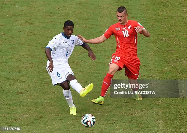 Switzerland's midfielder Granit Xhaka challenges Honduras' defender Juan Carlos Garcia during the Group E football match between Honduras and...