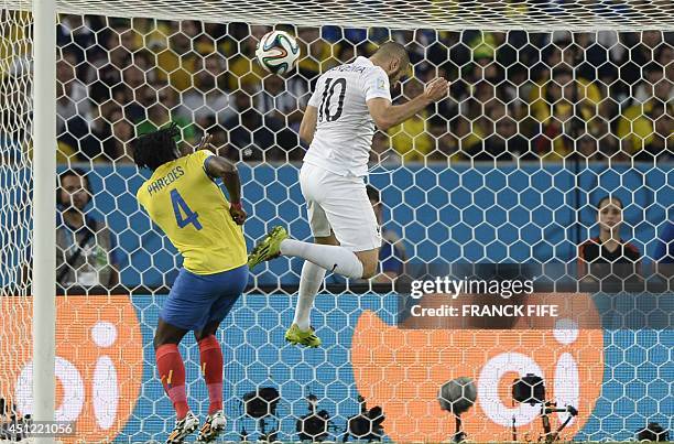 France's forward Karim Benzema and Ecuador's defender Juan Carlos Paredes vie for the ball during the Group E football match between Ecuador and...