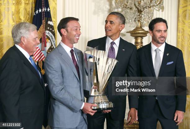 President Barack Obama stand with the 2013 NASCAR Sprint Cup Series Champion Jimmie Johnson , team owner Rick Hendrick , crew chief Chad Knaus ,...