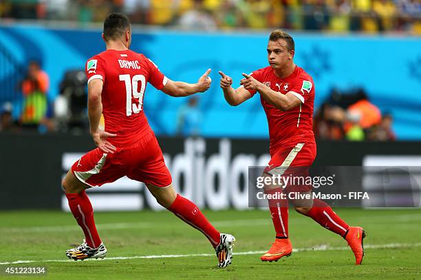 Xherdan Shaqiri of Switzerland celebrates scoring his team's second goal with his teammate Josip Drmic during the 2014 FIFA World Cup Brazil Group E...