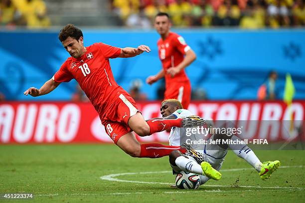 Admir Mehmedi of Switzerland is tackled by Brayan Beckeles of Honduras during the 2014 FIFA World Cup Brazil Group E match between Honduras and...