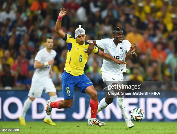 Christian Noboa of Ecuador and Paul Pogba of France compete for the ball during the 2014 FIFA World Cup Brazil Group E match between Ecuador and...