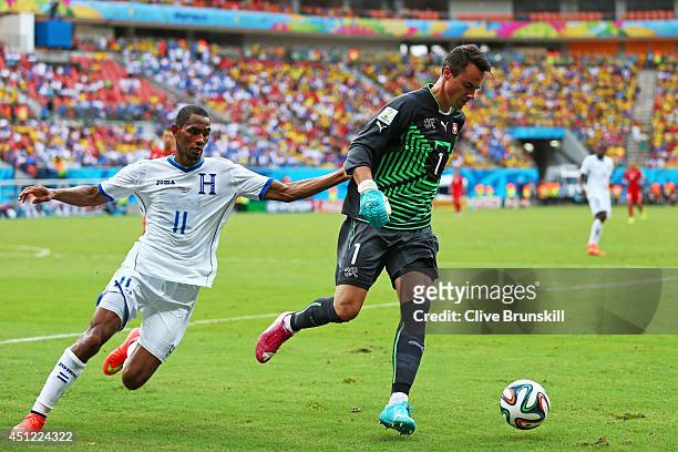 Goalkeepr Diego Benaglio of Switzerland controls the ball as Jerry Bengtson of Honduras gives chase during the 2014 FIFA World Cup Brazil Group E...