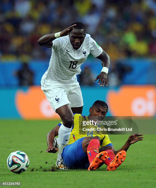 Oswaldo Minda of Ecuador challenges Moussa Sissoko of France during the 2014 FIFA World Cup Brazil Group E match between Ecuador and France at...