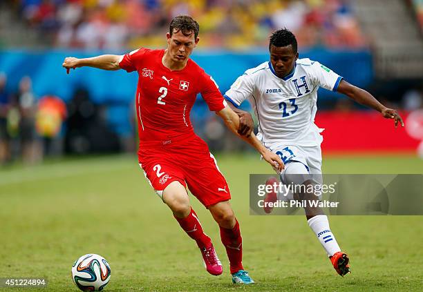Stephan Lichtsteiner of Switzerland and Marvin Chavez of Honduras compete for the ball during the 2014 FIFA World Cup Brazil Group E match between...