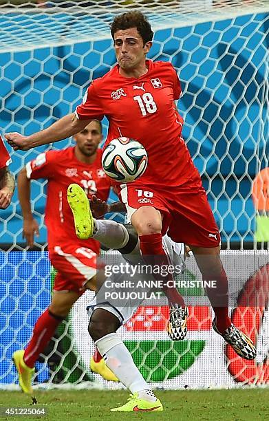 Honduras' defender Juan Carlos Garcia challenges Switzerland's forward Admir Mehmedi during the Group E football match between Honduras and...