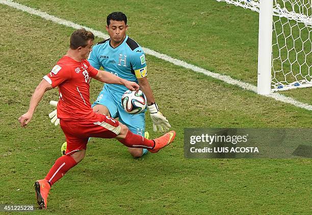 Honduras' goalkeeper Noel Valladares challenges Switzerland's midfielder Xherdan Shaqiri as he advances with the ball during the Group E football...