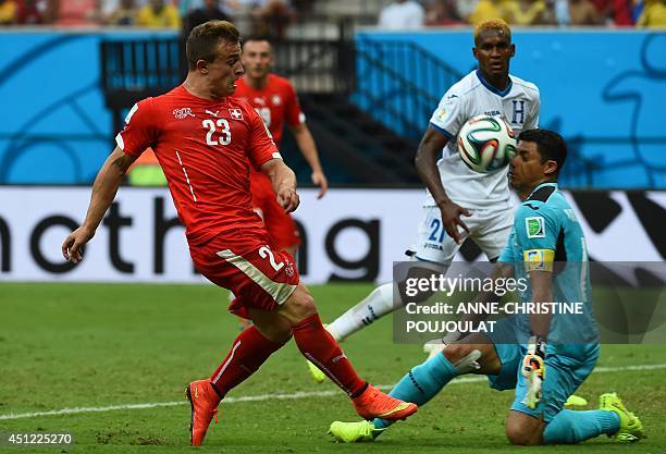 Honduras' goalkeeper Noel Valladares blocks a shot on goal by Switzerland's midfielder Xherdan Shaqiri during the Group E football match between...