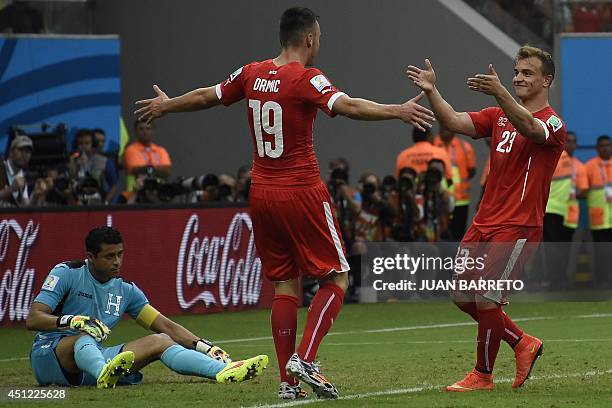 Honduras' goalkeeper and captain Noel Valladares reacts as Switzerland's midfielder Xherdan Shaqiri and Switzerland's forward Josip Drmic celebrate...