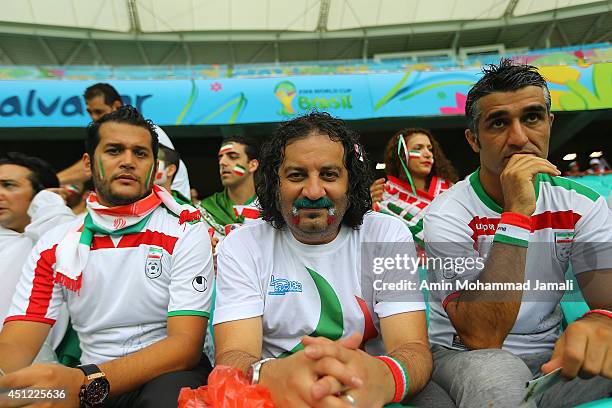 Iranian Artists Pejman Jamshidi and Merab Ghasem Khani and Siavash Kheyrabi look on during the 2014 FIFA World Cup Brazil Group F match between...