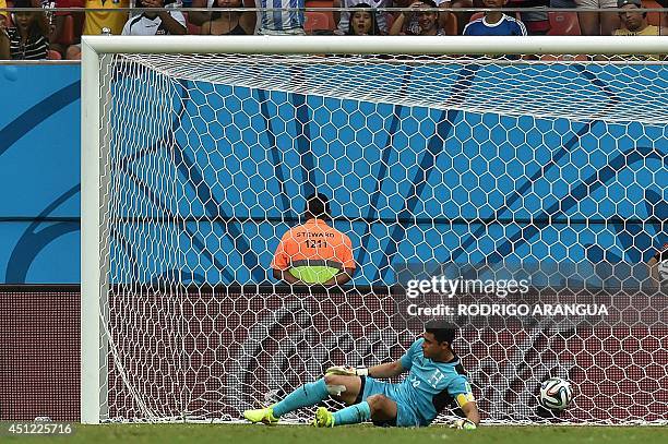 Honduras' goalkeeper and captain Noel Valladares fails to stop a goal during a Group E football match between Honduras and Switzerland at the...