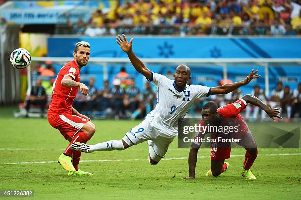 Jerry Palacios of Honduras is challenged by Valon Behrami and Johan Djourou during the 2014 FIFA World Cup Brazil Group E match between Honduras and...