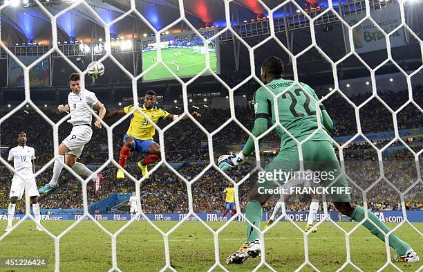 France's forward Olivier Giroud heads the ball as Ecuador's defender Gabriel Achilier defends and Ecuador's goalkeeper Alexander Dominguez prepares...