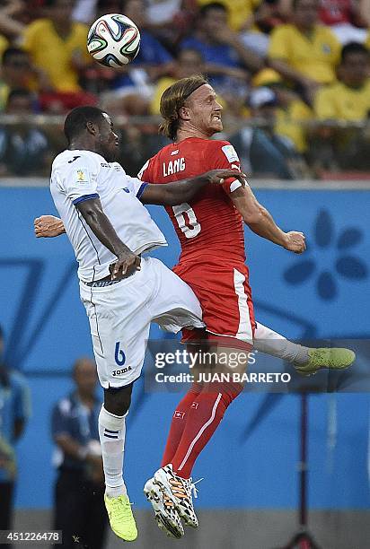 Switzerland's defender Michael Lang jumps to head the ball with Honduras' defender Juan Carlos Garcia during the Group E football match between...