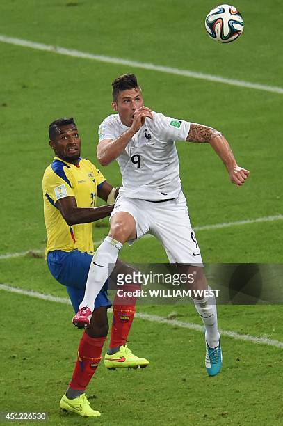 France's forward Olivier Giroud and Ecuador's defender Gabriel Achilier vie for the ball during the Group E football match between Ecuador and France...