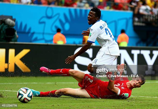 Marvin Chavez of Honduras is tackled by Stephan Lichtsteiner of Switzerland during the 2014 FIFA World Cup Brazil Group E match between Honduras and...