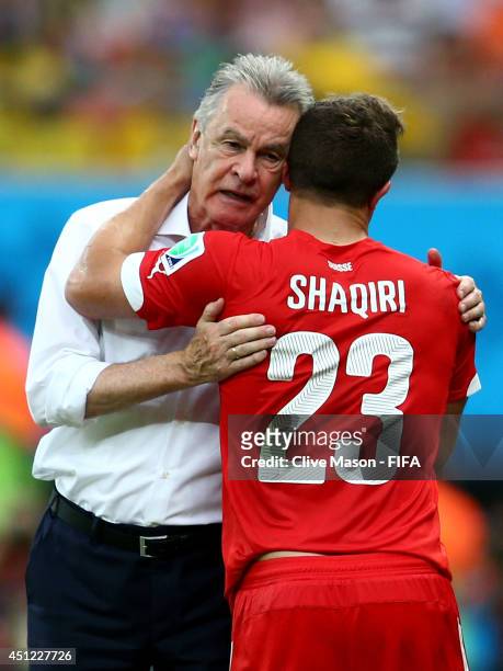 Xherdan Shaqiri of Switzerland is congratulated by head coach Ottmar Hitzfeld as he is replaced during the 2014 FIFA World Cup Brazil Group E match...