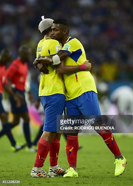 Ecuador's defender Gabriel Achilier consoles Ecuador's midfielder Cristhian Noboa following a 0-0 draw during a Group E football match between...
