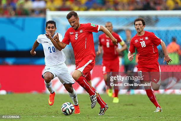 Haris Seferovic of Switzerland controls the ball as Jorge Claros of Honduras gives chase during the 2014 FIFA World Cup Brazil Group E match between...