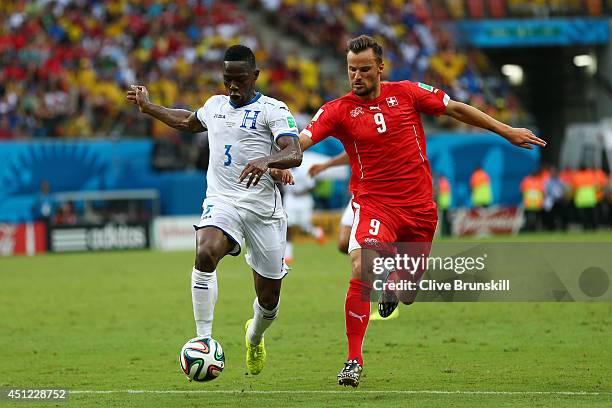 Maynor Figueroa of Honduras controls the ball as Haris Seferovic of Switzerland gives chase during the 2014 FIFA World Cup Brazil Group E match...