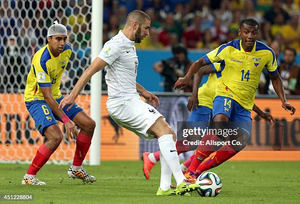 Karim Benzema of France is tackled by Oswaldo Minda of Ecuador during the 2014 FIFA World Cup Brazil Group E match between Ecuador and France at...