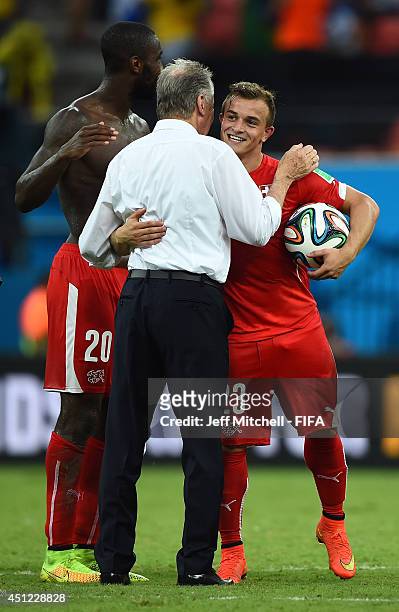 Xherdan Shaqiri of Switzerland is congratulated by head coach Ottmar Hitzfeld after his hat trick during the 2014 FIFA World Cup Brazil Group E match...