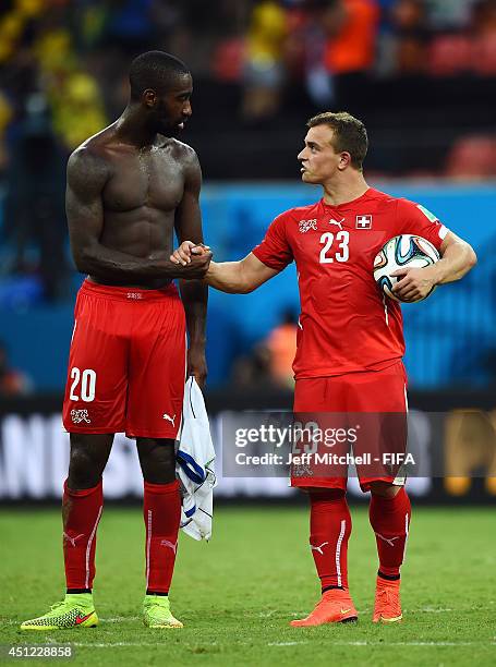 Xherdan Shaqiri of Switzerland is congratulated by Johan Djourou of Switzerland after his hat trick during the 2014 FIFA World Cup Brazil Group E...