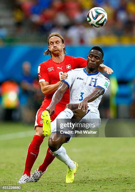 Michael Lang of Switzerland and Maynor Figueroa of Honduras compete for the ball during the 2014 FIFA World Cup Brazil Group E match between Honduras...