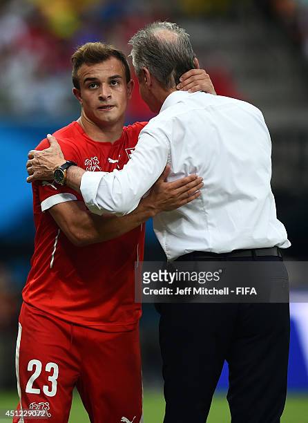 Xherdan Shaqiri of Switzerland is congratulated by head coach Ottmar Hitzfeld as he is replaced during the 2014 FIFA World Cup Brazil Group E match...