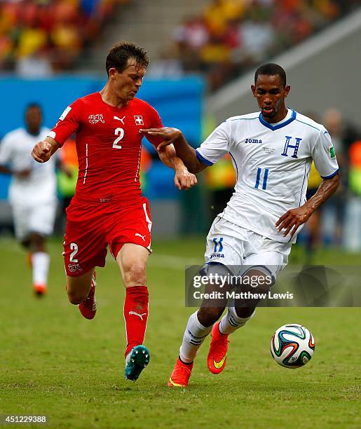 Stephan Lichtsteiner of Switzerland and Jerry Bengtson of Honduras compete for the ball during the 2014 FIFA World Cup Brazil Group E match between...