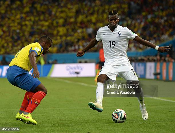 France's Paul Pogba vies for the ball with Ecuador's Gabriel Achilier during the 2014 FIFA World Cup Group E soccer match between France and Ecuador...