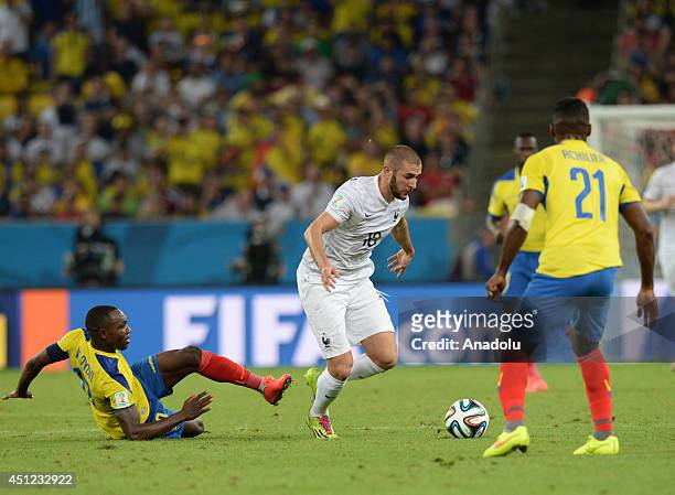 France's Karim Benzama vies for the ball with Ecuador's Gabriel Achilier and Walter Ayovi during the 2014 FIFA World Cup Group E soccer match between...