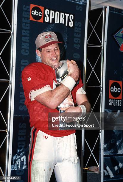 Steve Young of the San Francisco 49ers holds the Vince Lombardi trophy after the 49ers defeated the San Diego Chargers in Super Bowl XXIX on January...