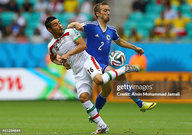 Reza Ghoochannejhad of Iran in action against Avdija Vrsajevic during the 2014 FIFA World Cup Brazil Group F match between Bosnia and Herzegovina and...