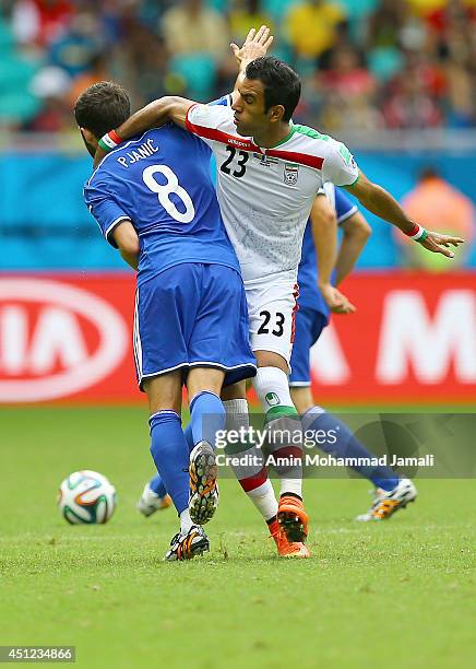 Mehrdad Pooladi of Iran in action against Miralem Pjanic during the 2014 FIFA World Cup Brazil Group F match between Bosnia and Herzegovina and Iran...