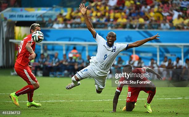 Jerry Palacios of Honduras is challenged by Valon Behrami and Johan Djourou during the 2014 FIFA World Cup Brazil Group E match between Honduras and...