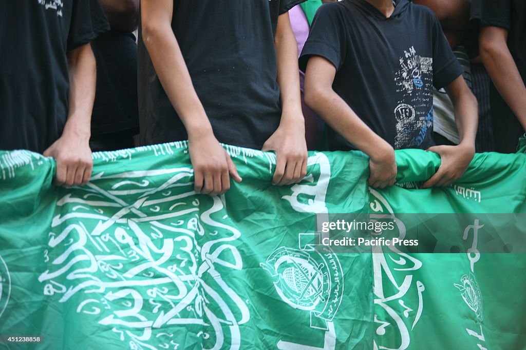 Hamas supporter children carry Hamas flag during a march...