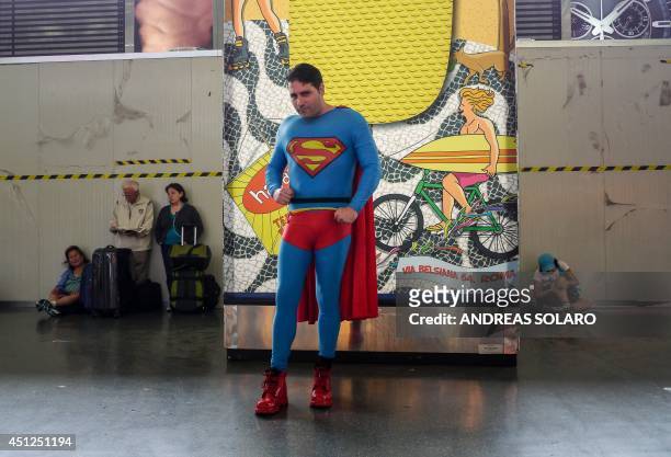 An unidentified man wearing a costume of Superman poses at Rome's Stazione Termini railway station, on June 26, 2014. AFP PHOTO / ANDREAS SOLARO /...