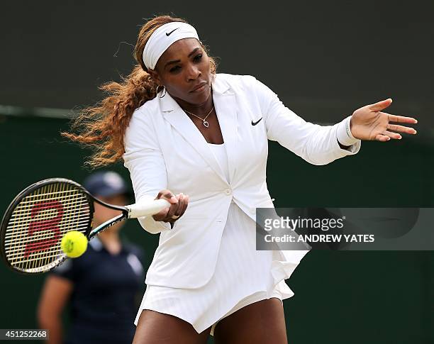 Player Serena Williams warms up before the start of her women's singles second round match against Russia's Chanelle Scheepers on day four of the...