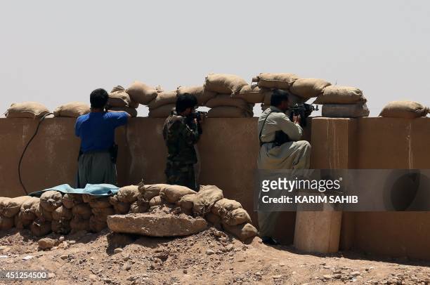Iraqi Kurdish Peshmerga forces hold a position on the front line in the village of Sulaiman Bek, located between the capital Baghdad and the northern...
