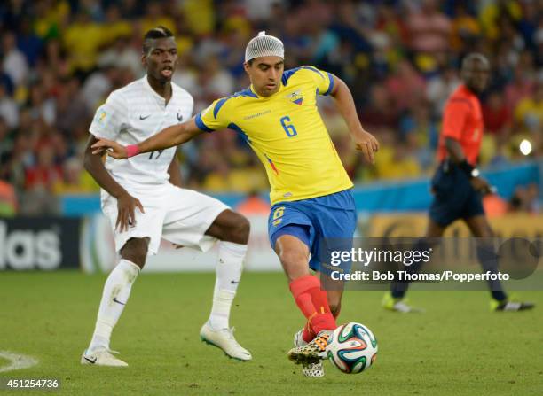 Cristhian Noboa of Ecuador with Paul Pogba of France during the 2014 FIFA World Cup Brazil Group E match between Ecuador and France at Maracana on...