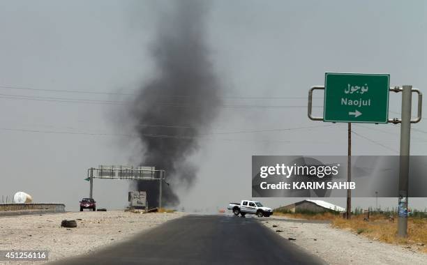 Smoke billows from an area controlled by the Islamic State of Iraq and the Levant between the Iraqi towns of Naojul and Tuz Khurmatu, both located...