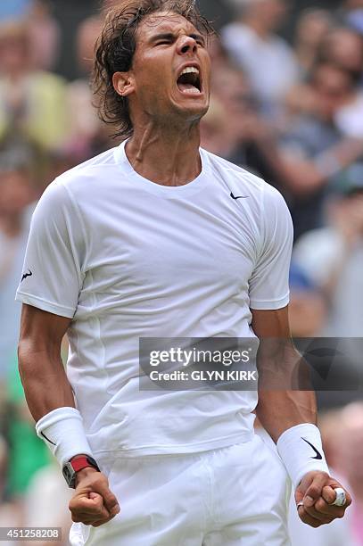 Spain's Rafael Nadal celebrates beating Czech Republic's Lukas Rosol during their men's singles second round match on day four of the 2014 Wimbledon...