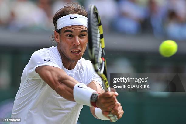 Spain's Rafael Nadal returns against Czech Republic's Lukas Rosol during their men's singles second round match on day four of the 2014 Wimbledon...