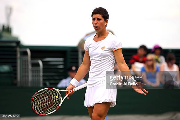 Carla Suarez Navarro of Spain reacts during her Ladies' Singles second round match against Zarina Diyas of Kazakhstan on day four of the Wimbledon...